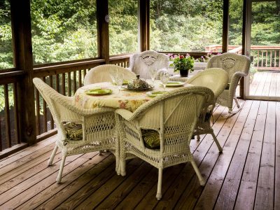 A lovely deck filled with chairs. It looks like a great time to be outside.